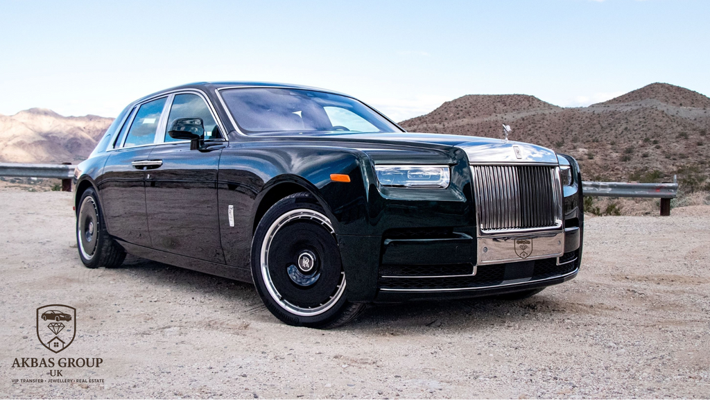Black luxury car on a desert road with mountains in the background
