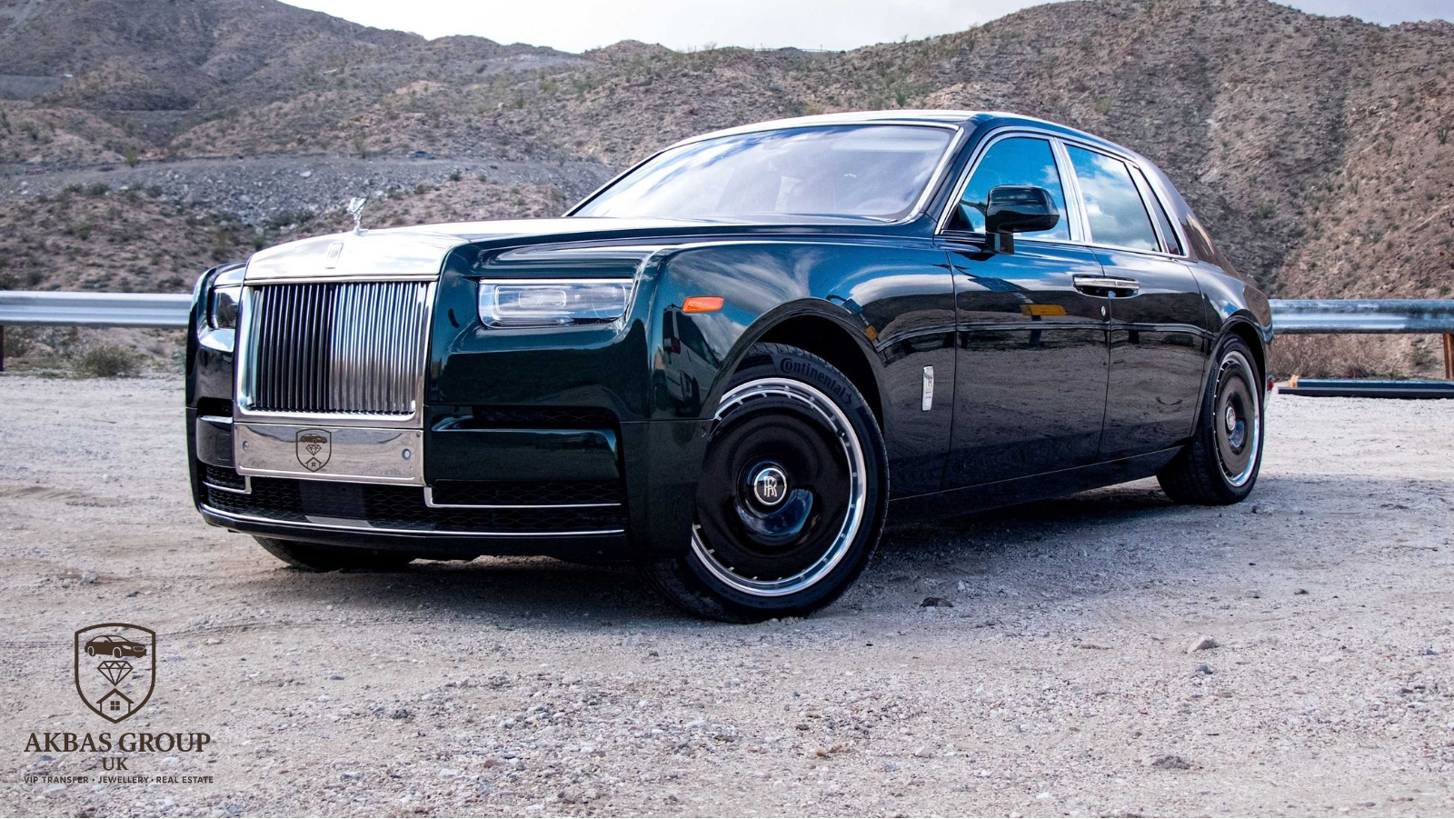 Luxury car parked on a road with mountains in the background