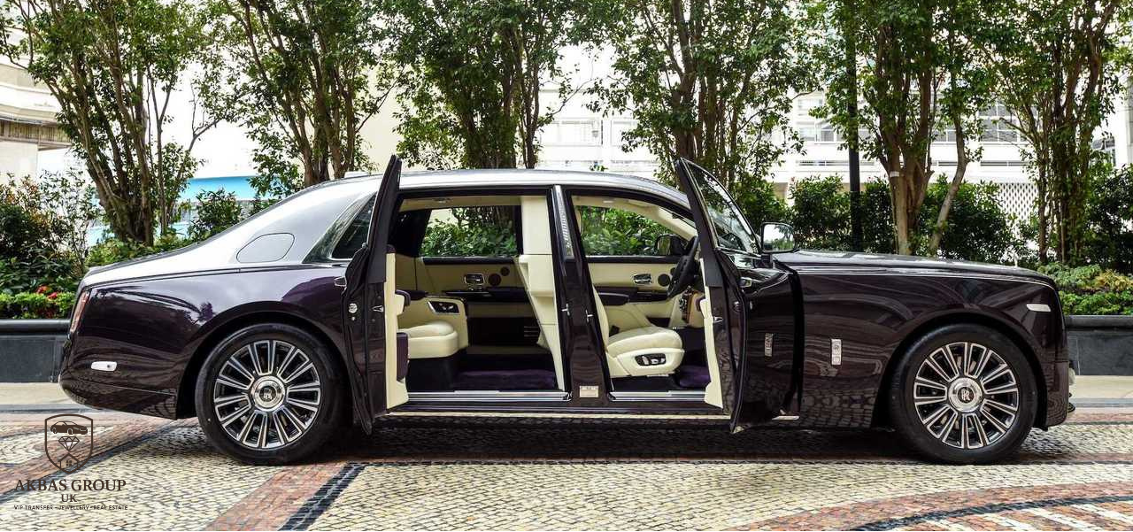 Luxury black car with open doors on a tree-lined street